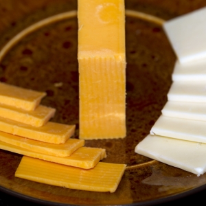 Cheese low-fat cheddar and Colby sliced close up horizontal