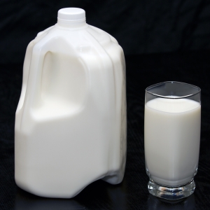 Milk LowFat in glass with full jug horizontal from above