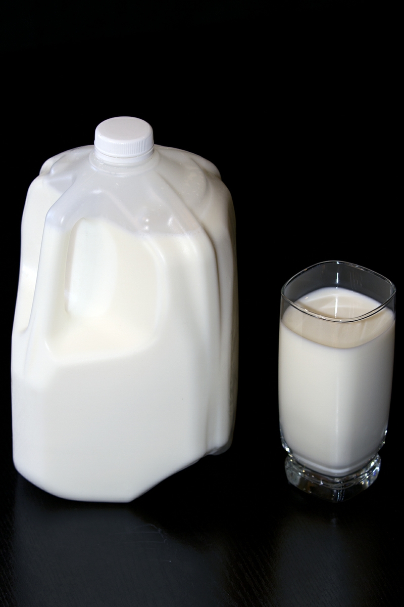 Milk LowFat in glass with full jug verticle from above