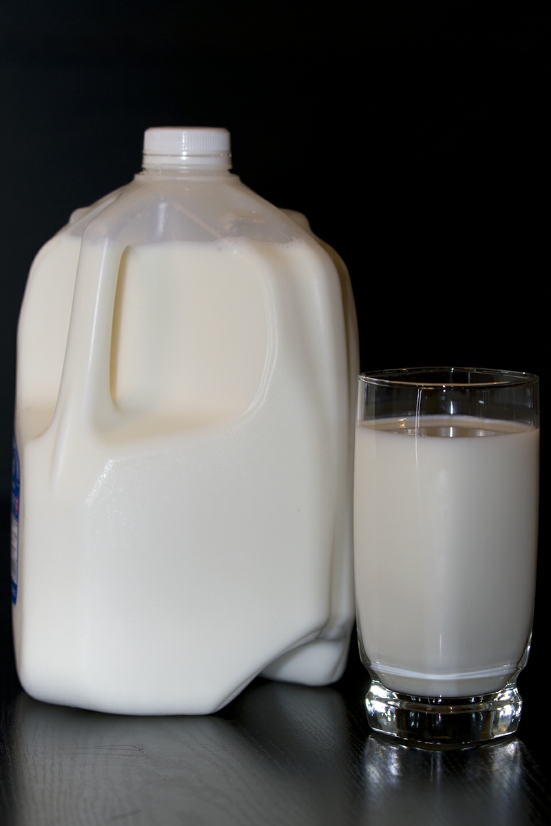Milk LowFat in glass with full jug verticle straight on