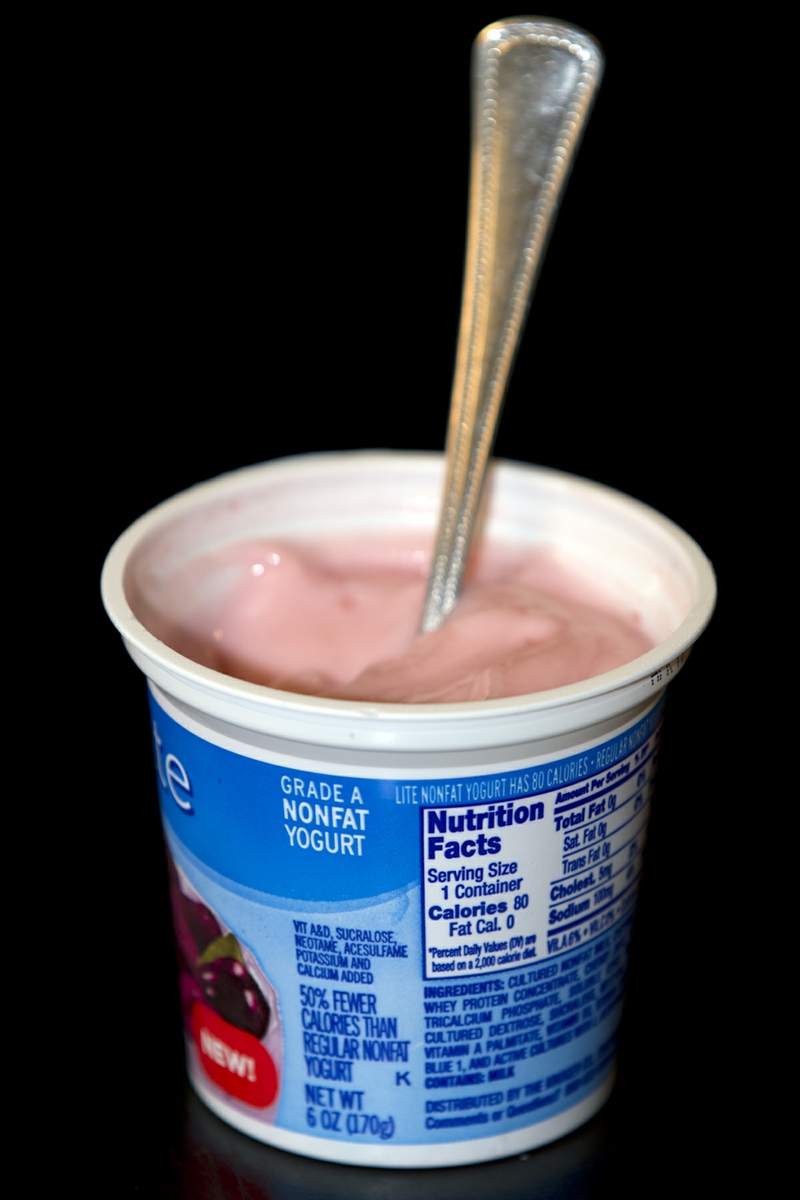 Yogurt LowFat flavored in cup with spoon verticle