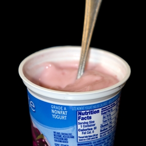 Yogurt LowFat flavored in cup with spoon verticle