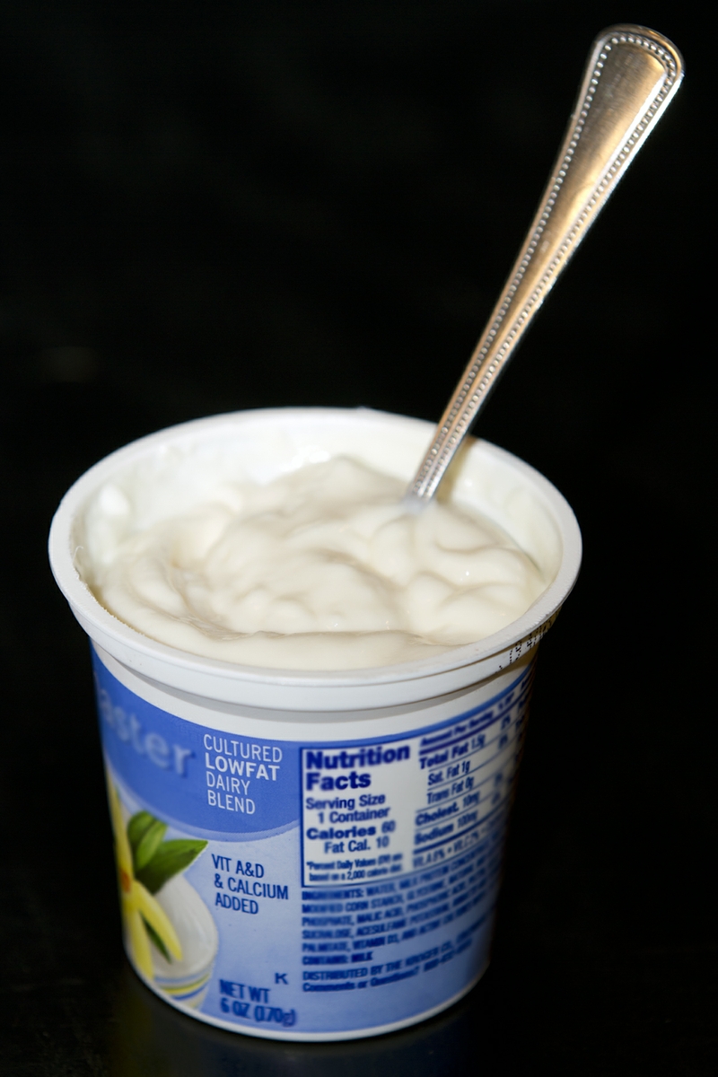 Yogurt LowFat plain in cup with spoon verticle