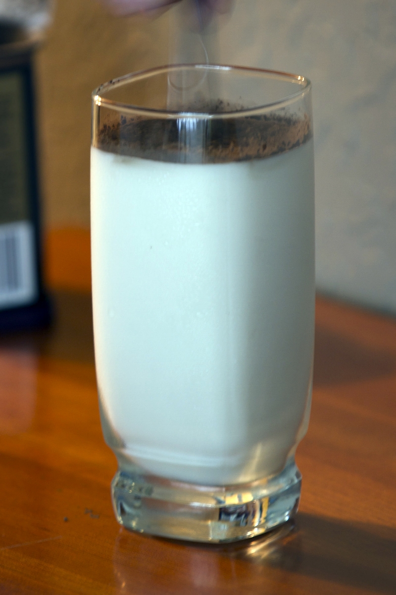 Cocoa Powder in glass of milk stirring
