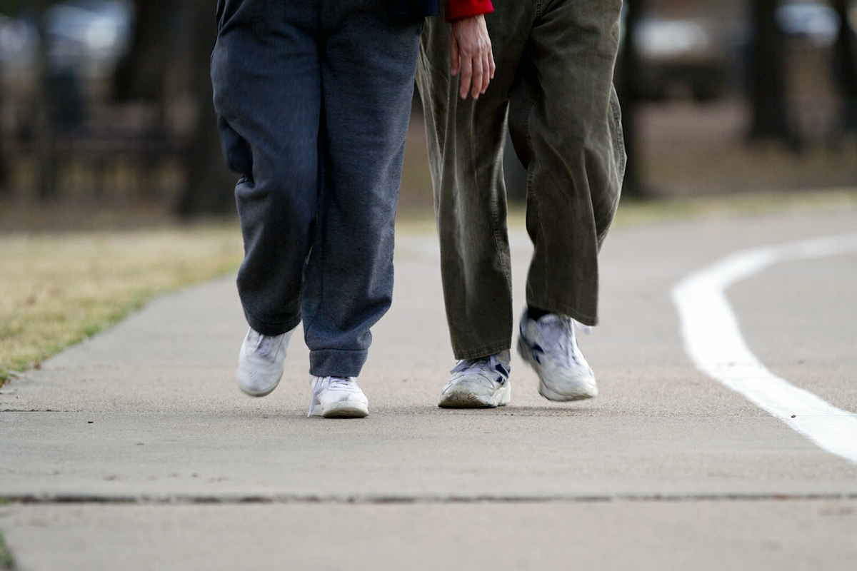 Walking - man and women toward - Outside track