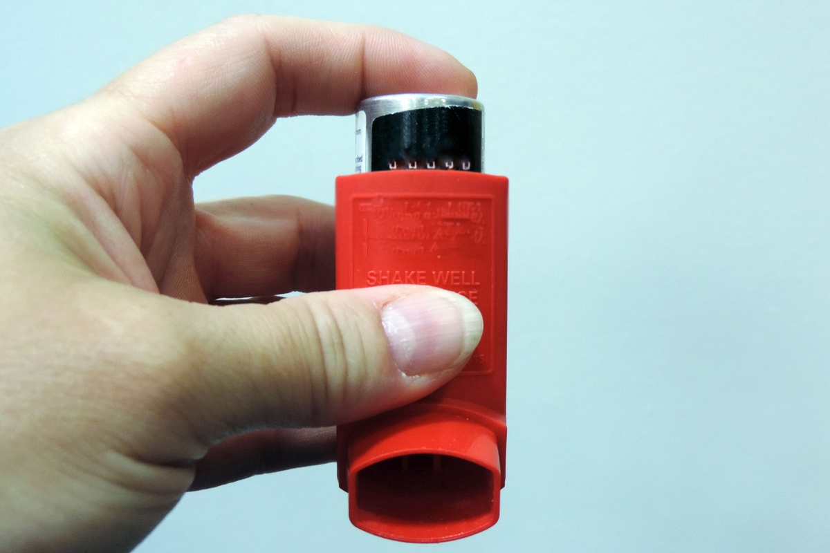 asthma inhaler in hand