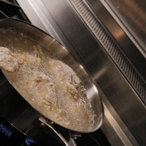 Chicken thighs frying