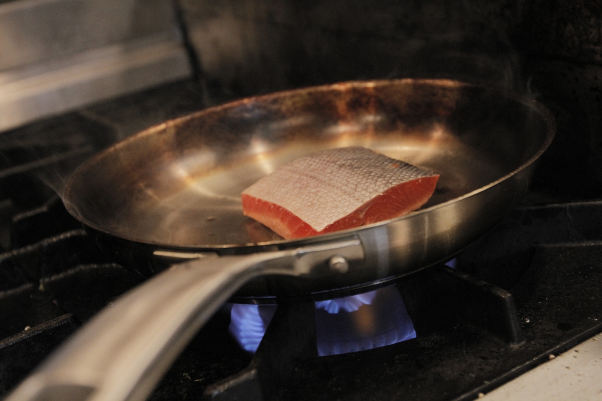 Salmon cooking in skillet