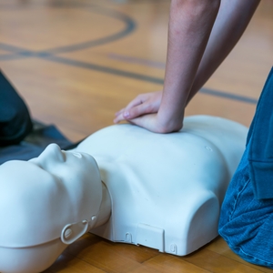 Child practicing CPR on manikin