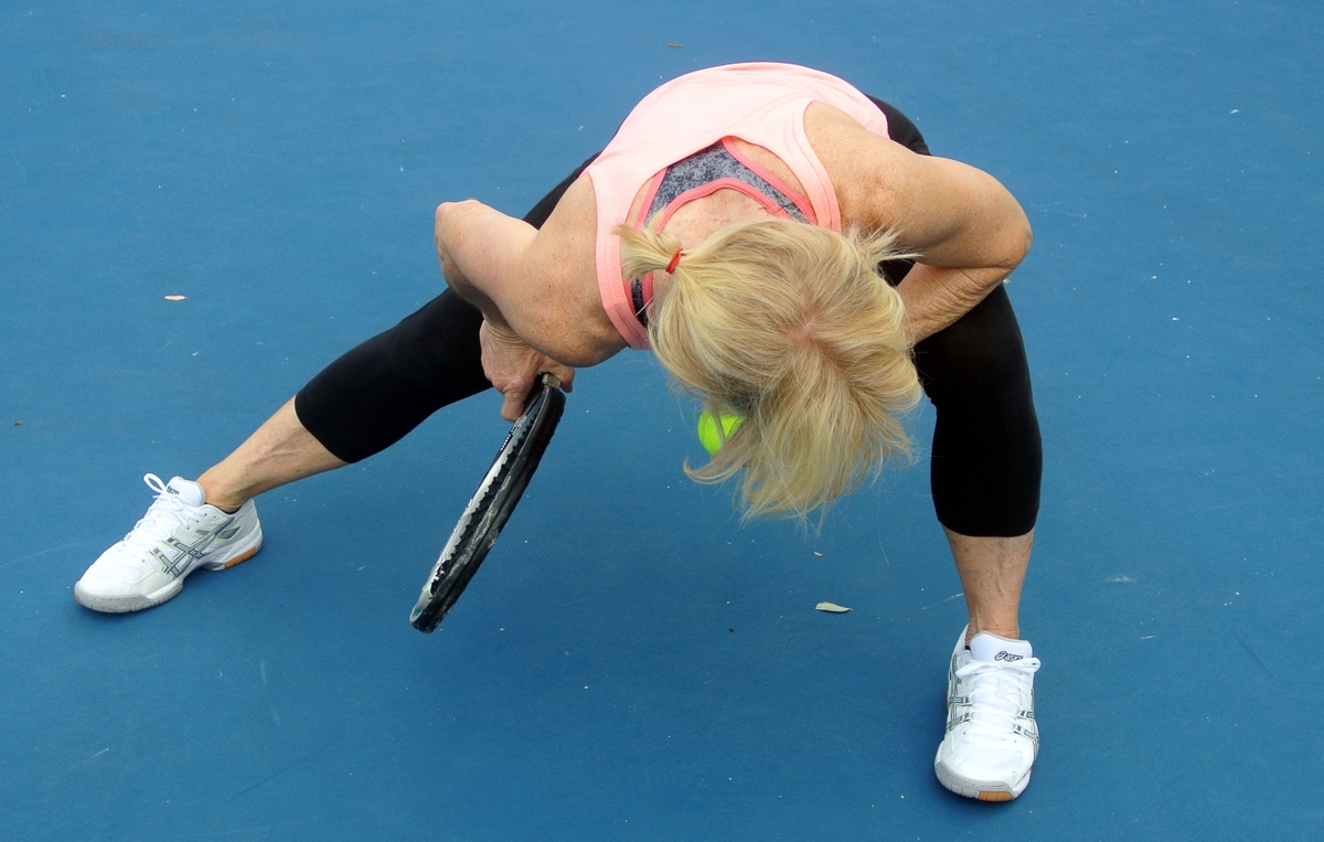 Tennis player stretching muscles
