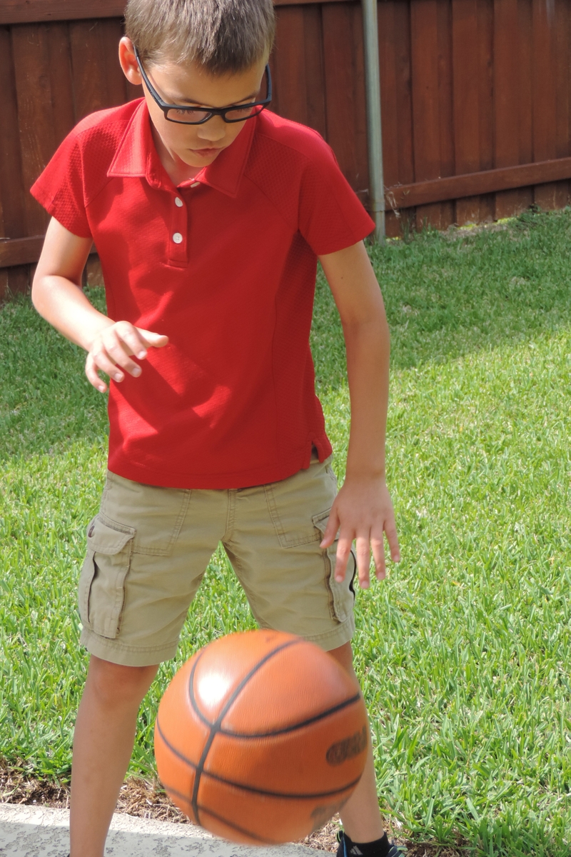 Boy playing with a basketball