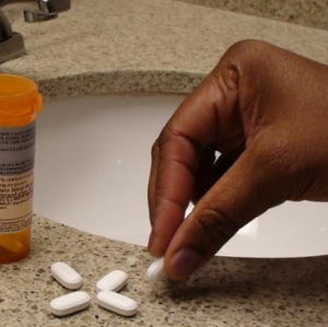 Opioids- women picking up pill