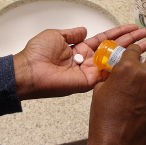 Opioids - women pouring out pill