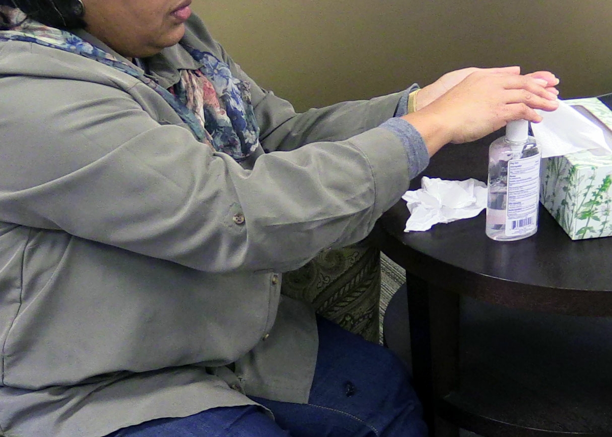 Woman using hand sanitizer