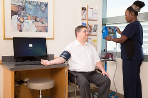 Male patient BP check by nurse