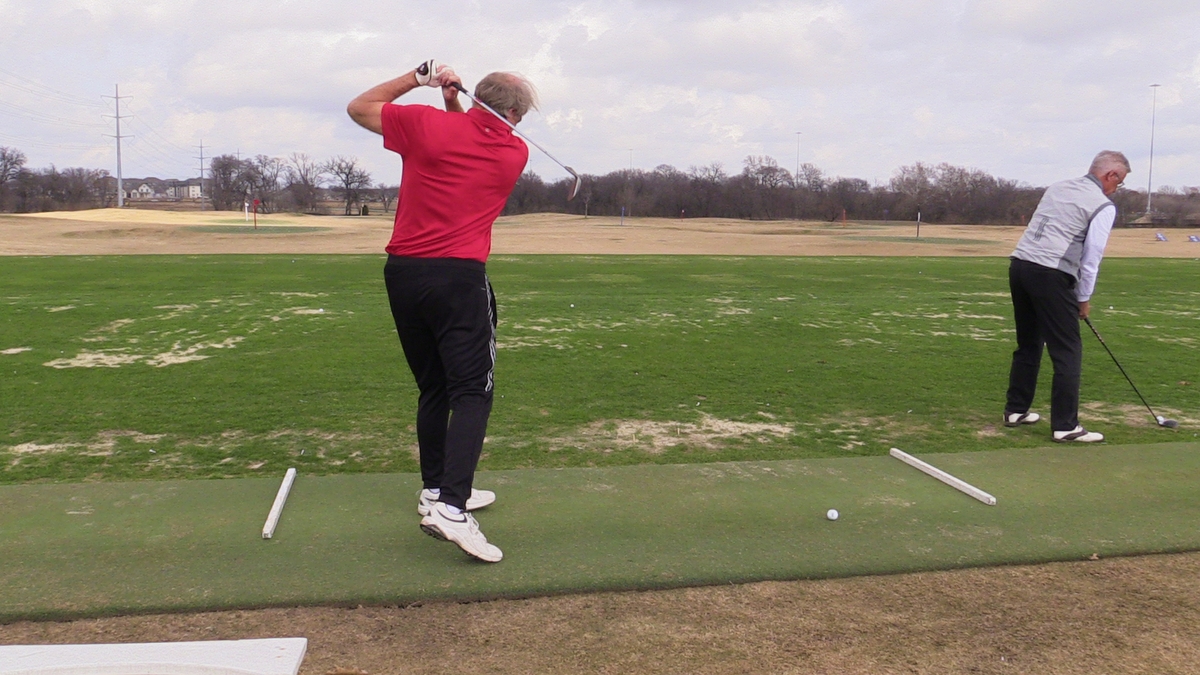 Men practicing golf swing