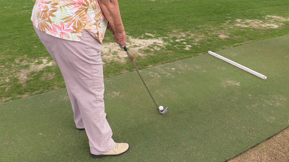 Woman golfing