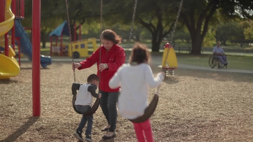 Woman playing with grandchildren at park
