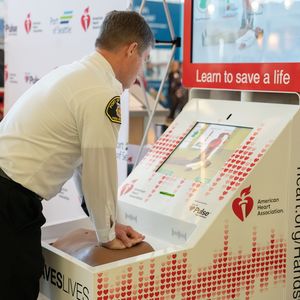 Port of Seattle Fire Chief demonstrating how to use a Hands-Only CPR kiosk