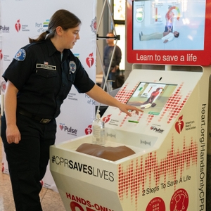 Seattle firefighter demonstrates how to use a CPR kiosk