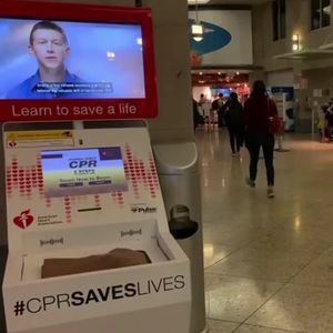 Travelers passing Hands-Only CPR kiosk at Seattle-Tacoma International Airport b-roll
