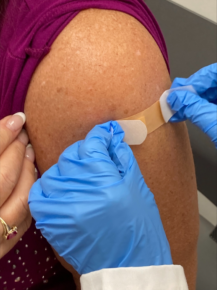 Flu shot -applying bandage close up