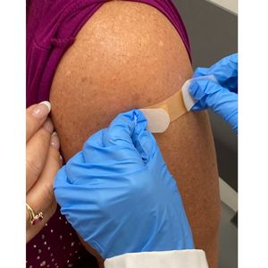 Flu shot -applying bandage close up