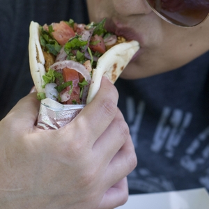 Eating a taco with veggies