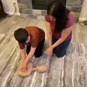 Parents showing children CPR techniques b-roll