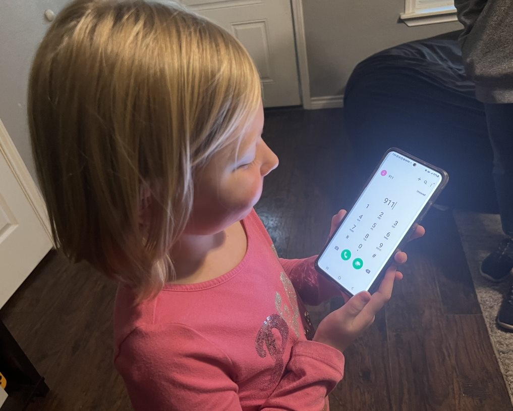 Child with 9-1-1 on phone