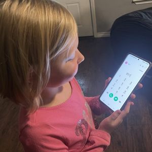 Child with 9-1-1 on phone