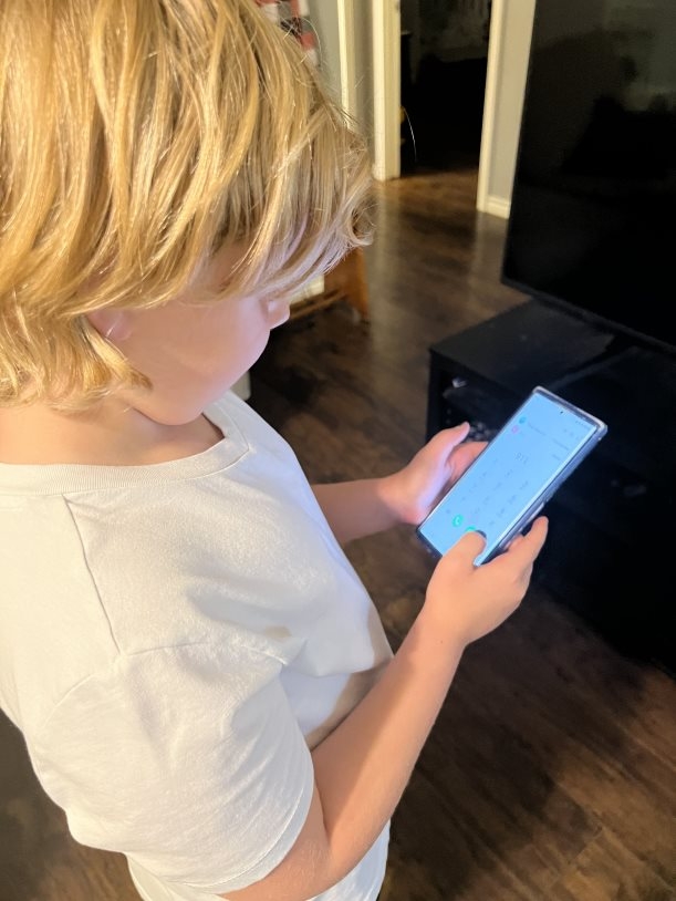 Child with phone to dial 9-1-1