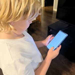 Child with phone to dial 9-1-1