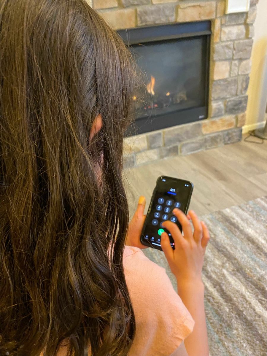 Young girl dialing 911