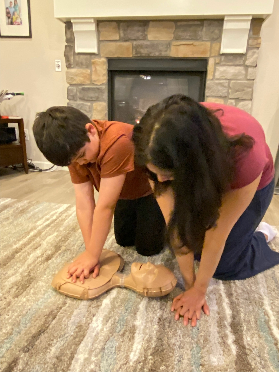 Mom showing son CPR