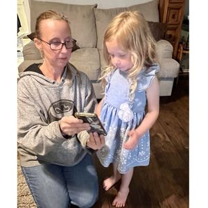 Woman showing child 9-1-1 on phone