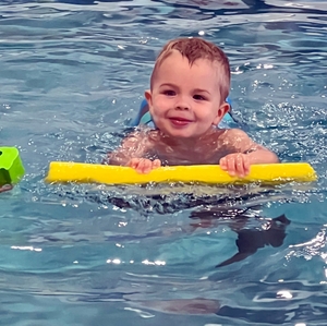 Toddler swimming with float device