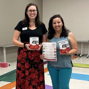 Community Impact Director Kelsey Williams and Linda Natera, founder and director of Sana Yoga