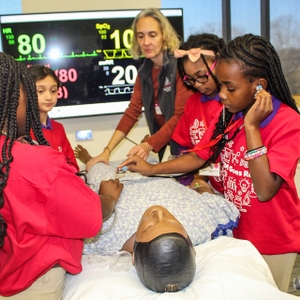 Participant checking heart beat at SC STEM Goes Red