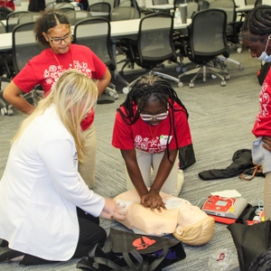 Participant doing hands-only CPR Compressions at Upstate SC STEM Goes Red