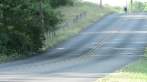 Cyclists on hilly roadway