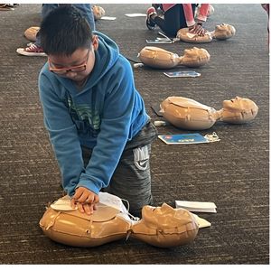 Youth learning CPR with Chiefs