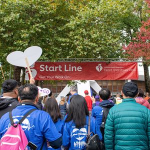 Walkers cross the start line at the 2023 Puget Sound Heart and Stroke Walk in Seattle