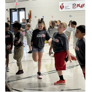 Students stretching while participating in NFLPLAY60