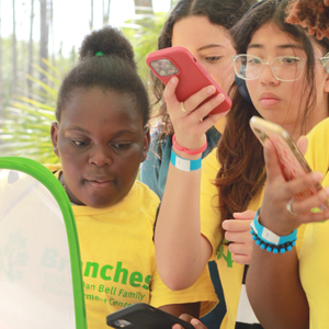 Students take photos during exhibit presentation