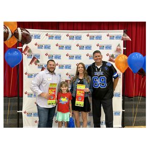 Student winner and family hold up Superbowl ticket
