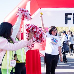 Rima Maldonado, a cardiac arrest survivor, rings the survivor bell during the 2023 Central Valley Heart and Stroke Walk