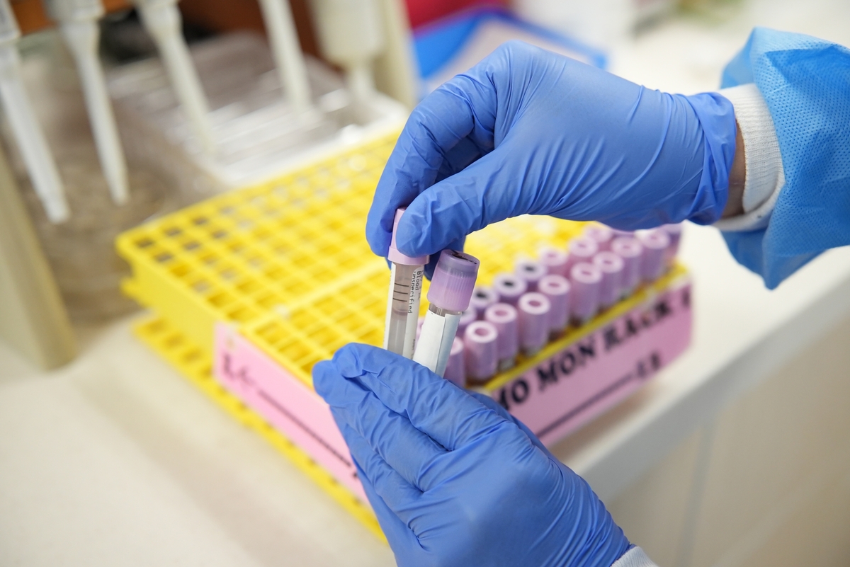 Lab tech with mutliple vials