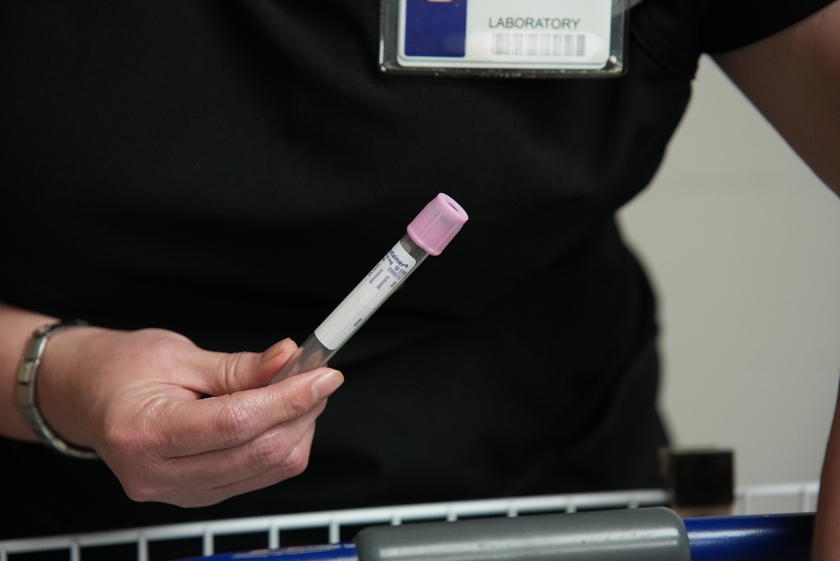 Lab tech with vial