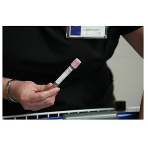 Lab tech with vial